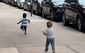 Stillshot of video showing toddlers fleeing one another